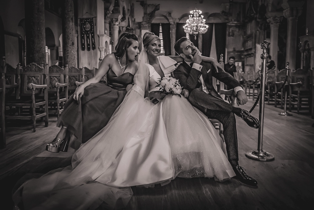 a koumbara poses with the bride and groom after the greek orthodox wedding ceremony