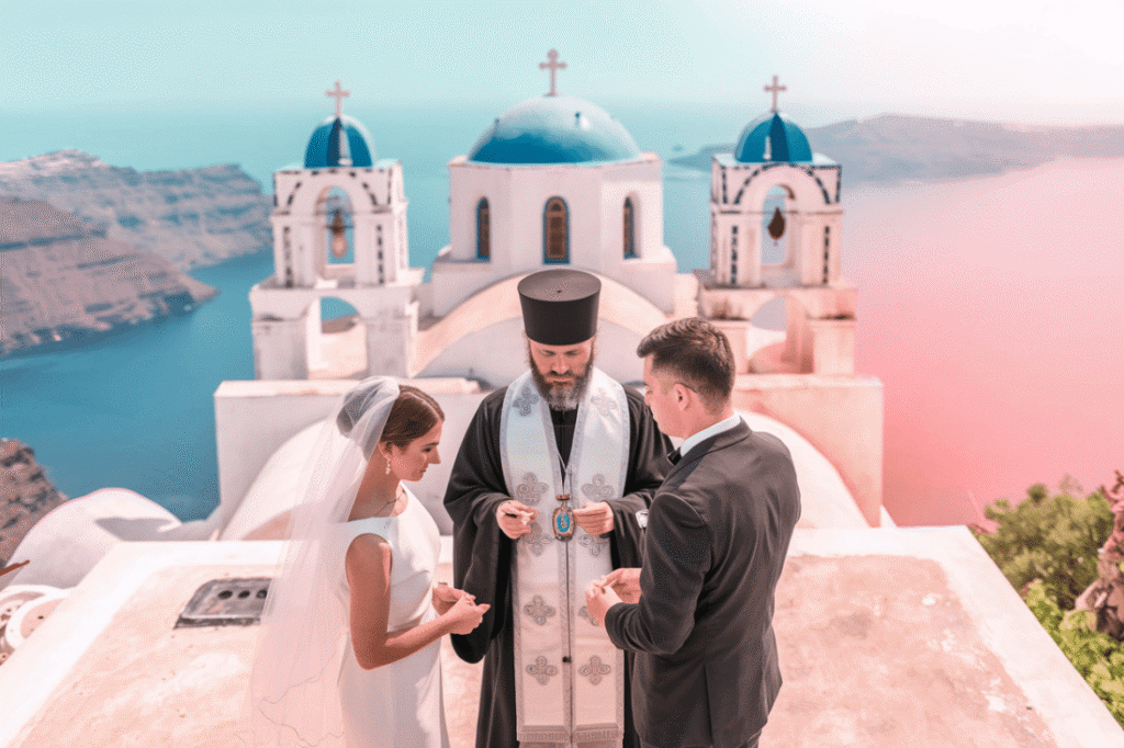 A couple at a wedding ceremony in Greece overlooking the beautiful Aegean sea.