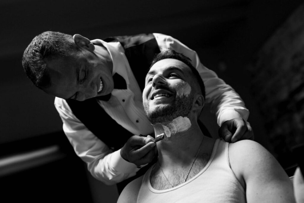 Koumbaro performing the traditional shaving of the groom before a Greek Orthodox wedding ceremony.