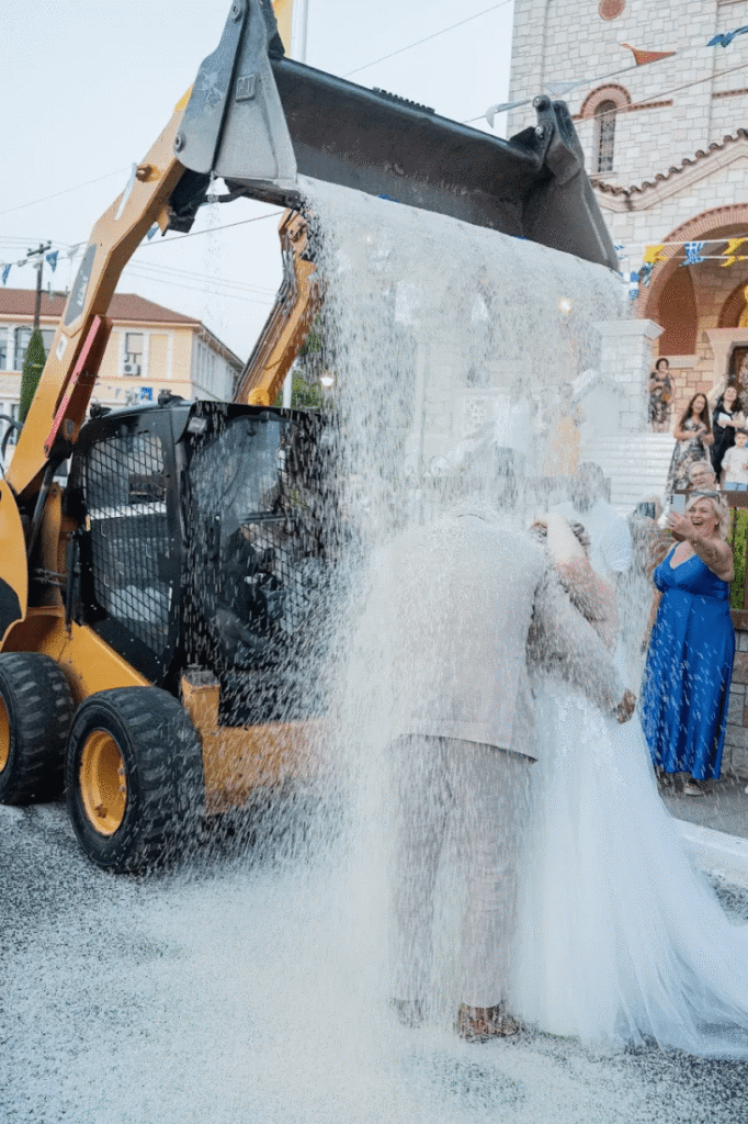 Guests throwing rice at the newlyweds outside the church, a Greek tradition symbolizing prosperity and fertility.