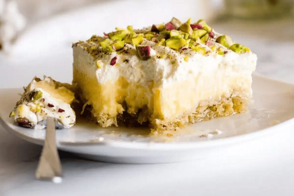 a modern version of traditional greek dessert kantaifi cake with pistachio and filos angel hair
