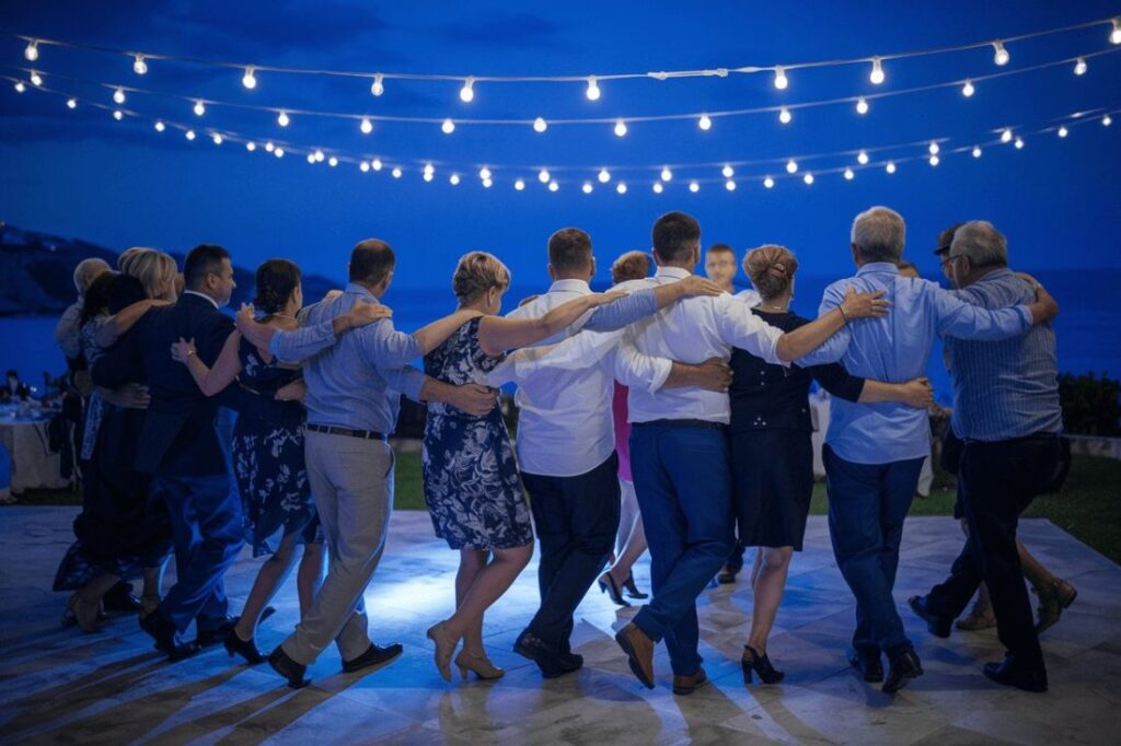 Wedding goers dancing the Sirtaki at a greek wedding.