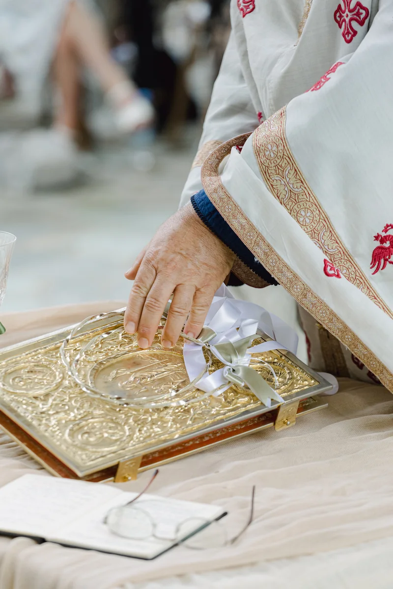 priest blessing the stefana at a greek orthodox wedding