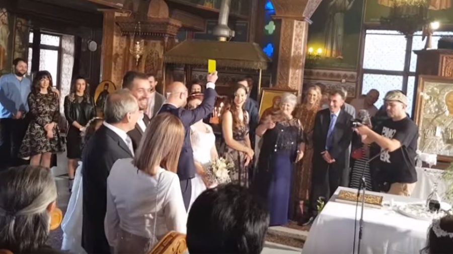 a broom give the bride a yellow card for stomping on his foot during the greek orthodox wedding ceremony