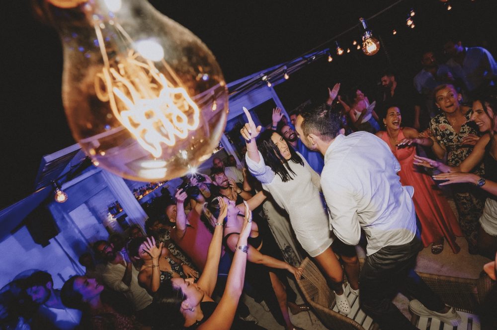 An image of party goers dancing at a wedding in greece