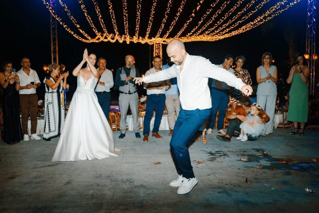 A man dancing the greek zeibebiko at a greek wedding