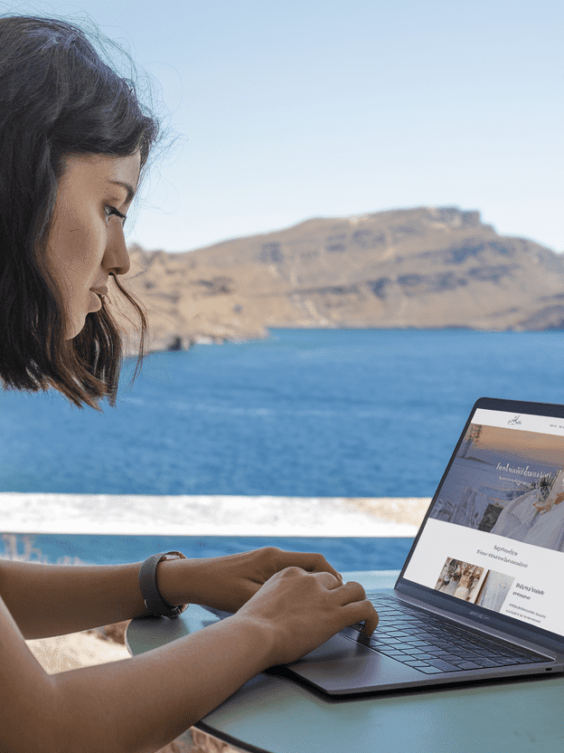 A woman by the seaside planning her Destination wedding in Greece