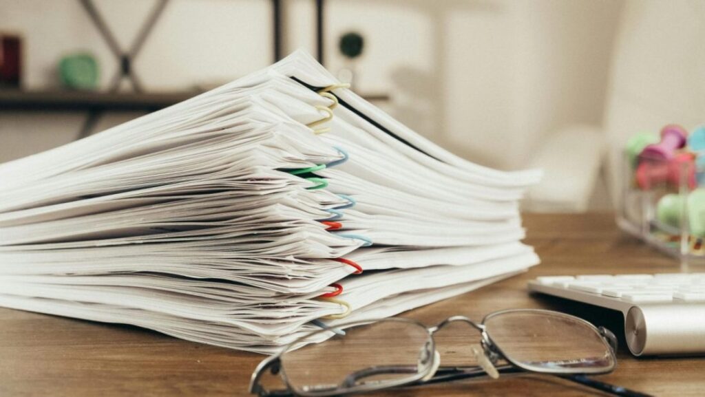 a stack of greek wedding paperwork and legal documents