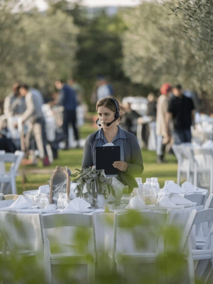 A wedding planner in Greece coordinating setup for an olive grove wedding
