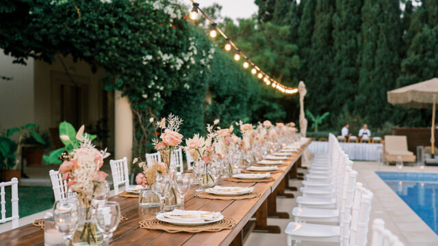 a long wooden table set at a rhodes greek wedding venue
