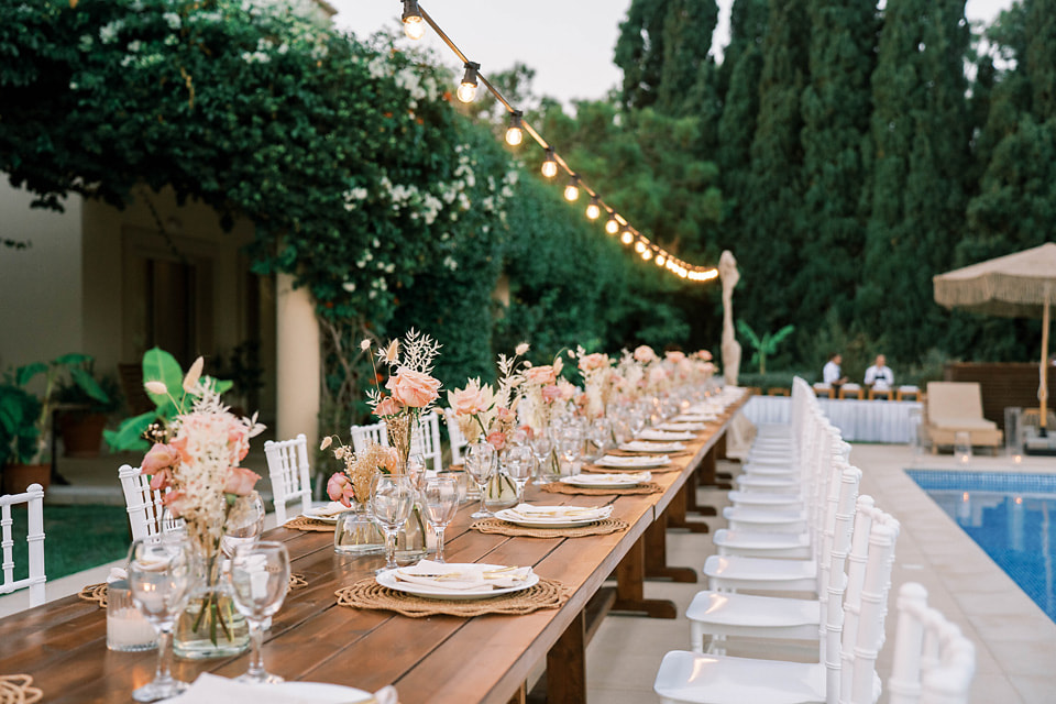 a long wooden table set at a rhodes greek wedding venue
