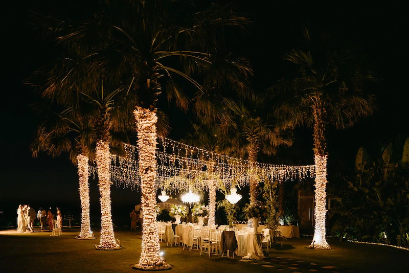 sea view by enkipo wedding venue in crete lights wrapped around palm trees