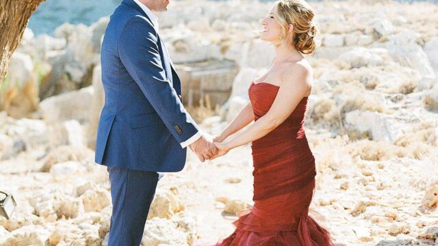 a bride and groom hold hands at a destination wedding rhodes