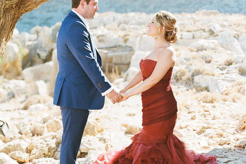 a bride and groom hold hands at a destination wedding rhodes
