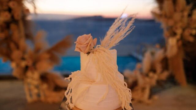 a white wedding cake with a flower