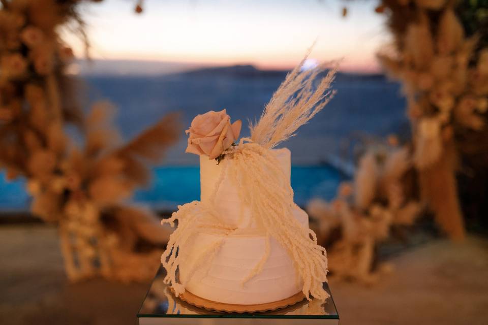 a white wedding cake with a flower