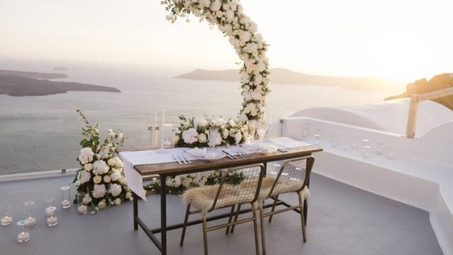 santorini wedding table with a flower arch