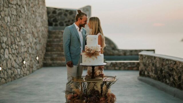 bride and groom in front of their wedding cake