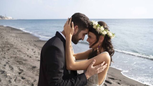 bride and groom embracing on a greek beach