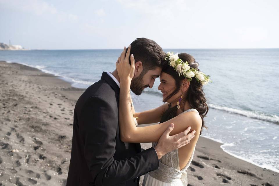 bride and groom embracing on a greek beach