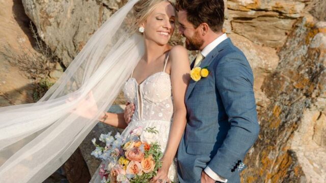 bride and groom posing at a santorini wedding
