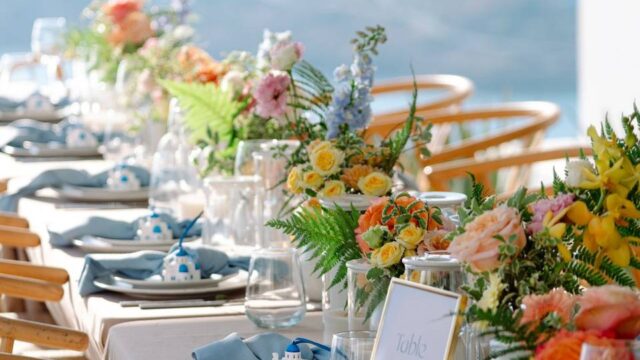 beautifully decorated wedding table in greece with the sea as a backdrop