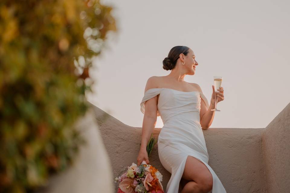 bride sipping champagne at a greek wedding