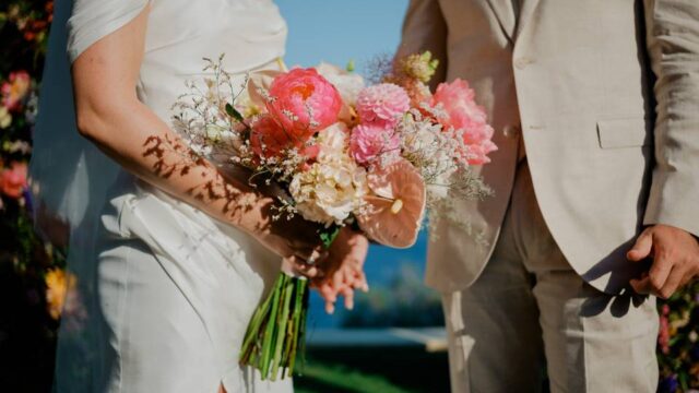 bride and groom at a greek wedding with a beautiful bridal bouquet
