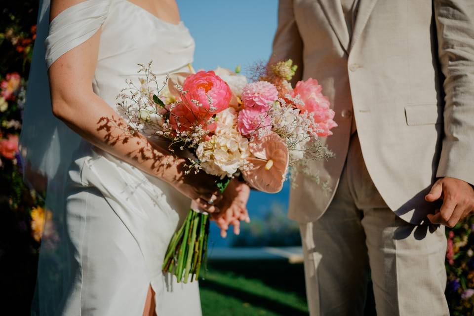 bride and groom at a greek wedding with a beautiful bridal bouquet