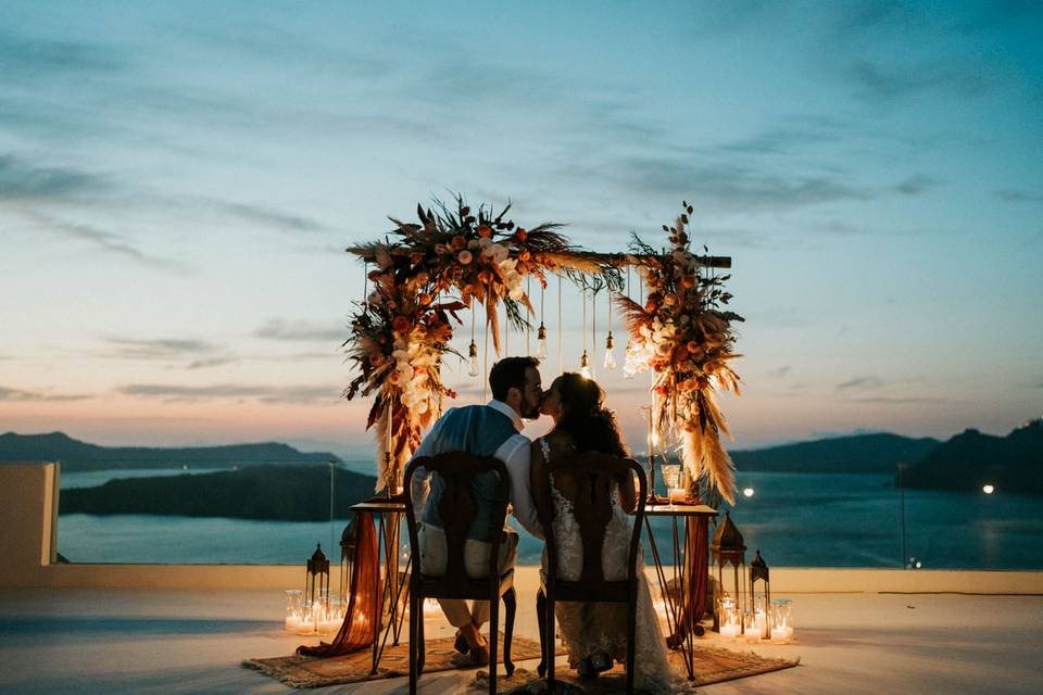 wedding in santorini and a view of the caldera in the backdrop