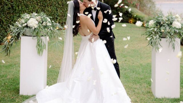 wedding couple kissing at greek wedding