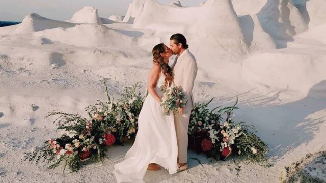 a wedding couple kissing at a destination wedding in santorini