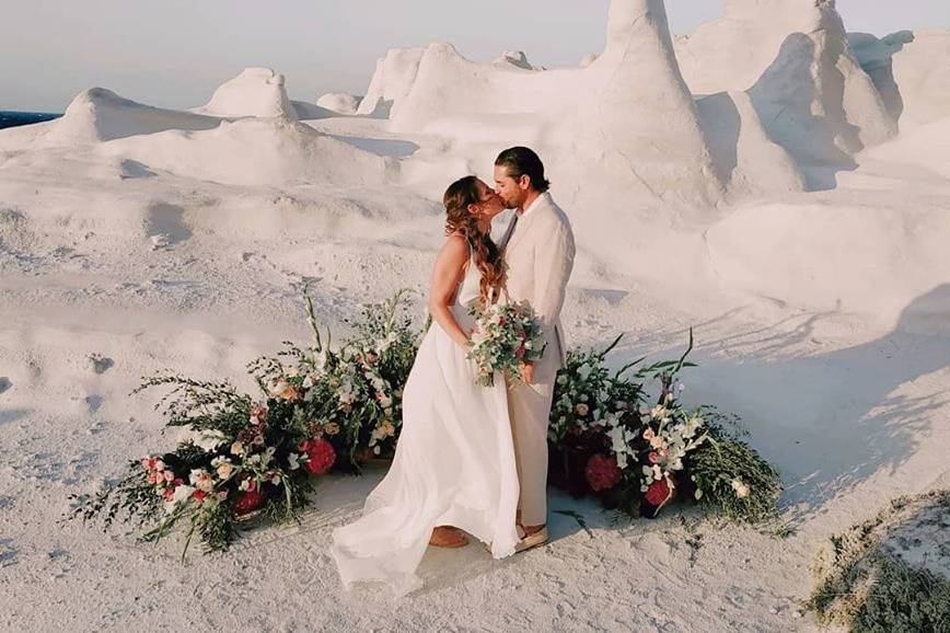 a wedding couple kissing at a destination wedding in santorini