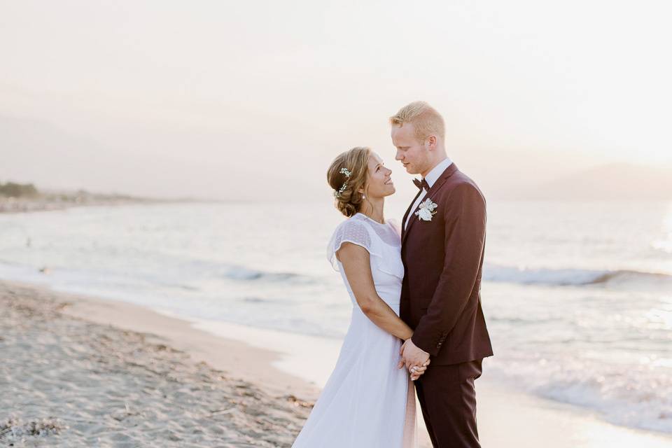 a wedding couple on the beach in greece