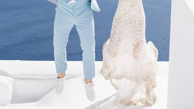 a couple jumping at a santorini destination wedding