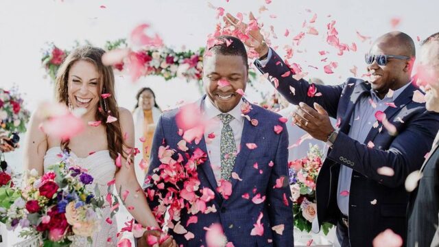 wedding couple showered in flowers at a greek wedding