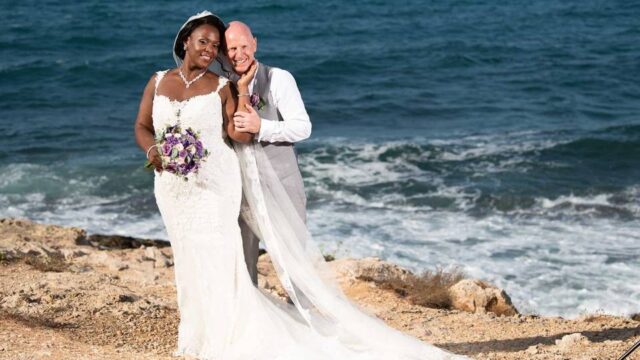 newlywed couple posing on the beach in greece