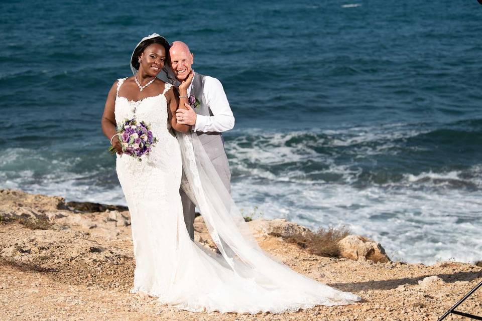 newlywed couple posing on the beach in greece