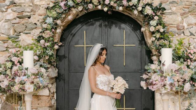 a beautiful bride surrounded by flowers at her greek wedding