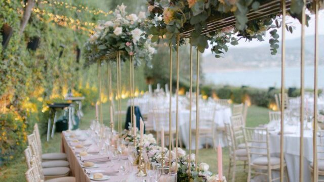 beatuifully set wedding table with flowers overhanging