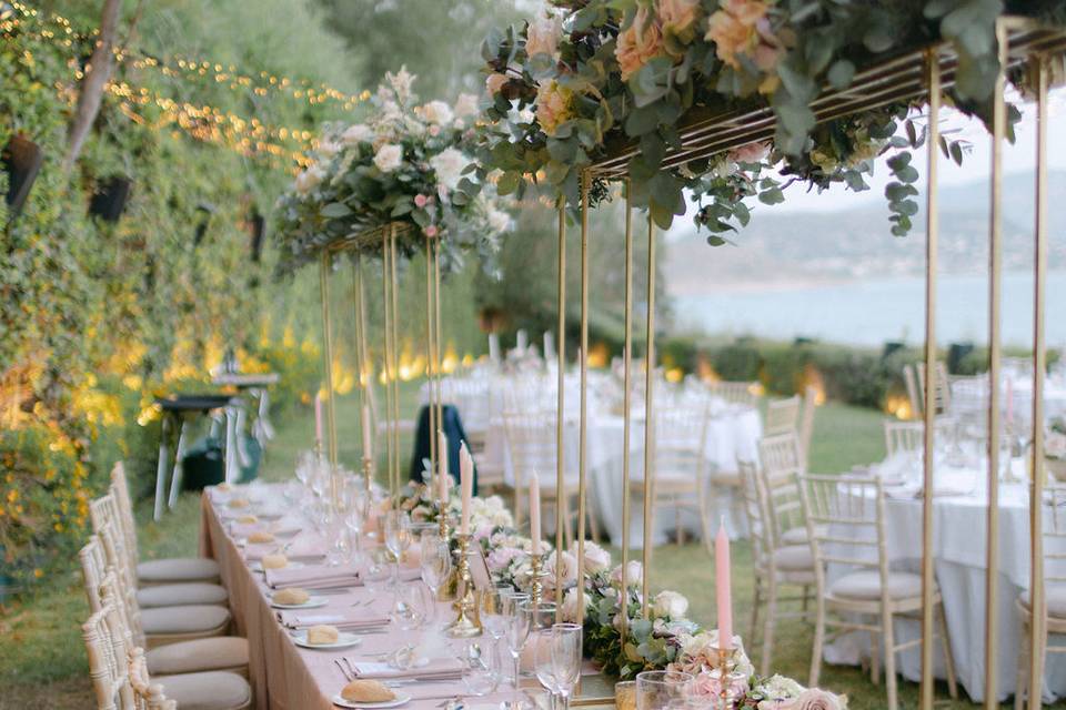beatuifully set wedding table with flowers overhanging
