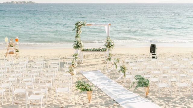 an altar setup for a wedding ceremony on a greek beach