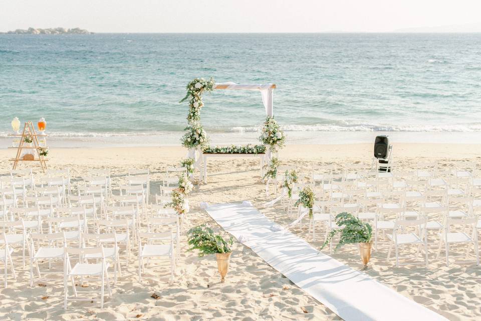 an altar set up for a wedding ceremony on an open Greek beach