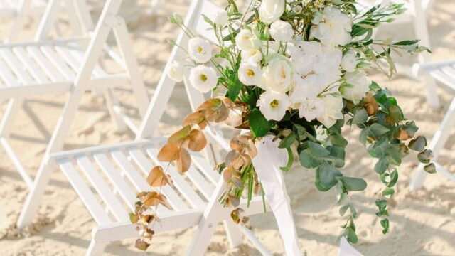 flowers on the beach decorating a chair