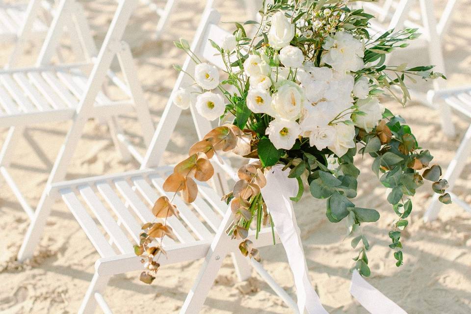 florals decorating a chair at a Greek island wedding