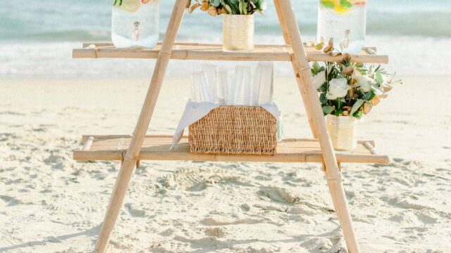 a water and flower station at a greek beach wedding