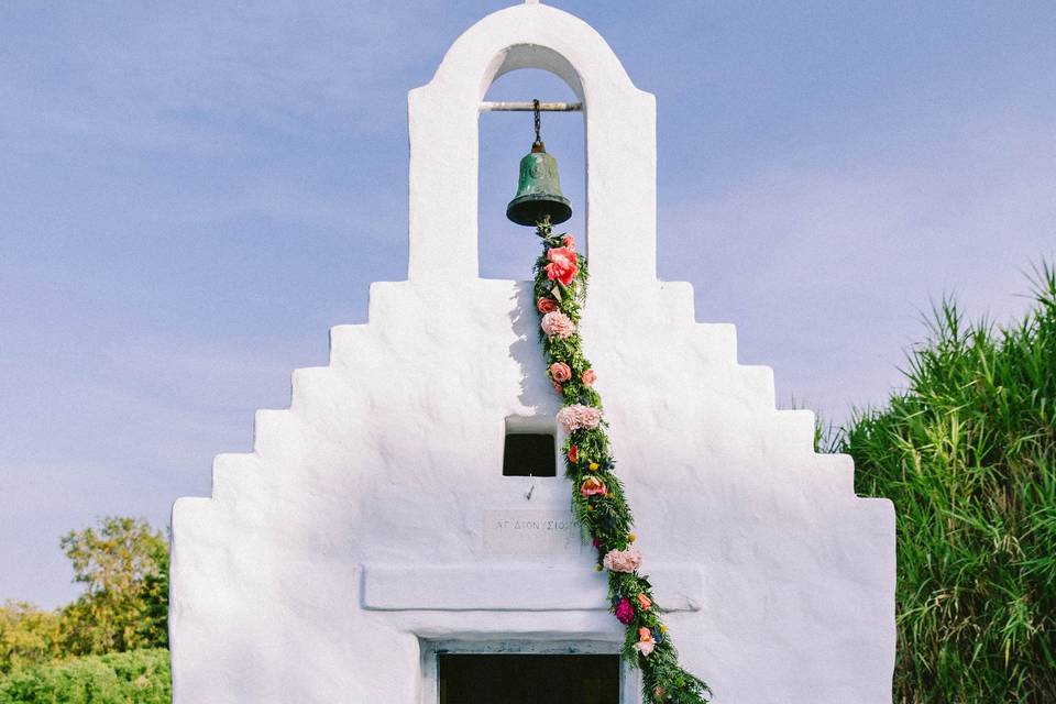beautifully decorated wedding chapel in greece with hanging flowers