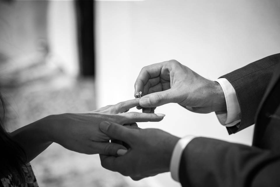a man putting a ring on a woman's finger in greece