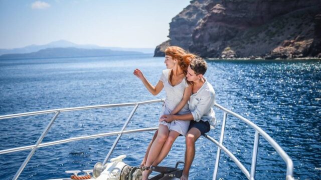 an engaged couple on a boat in greece