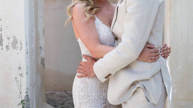 a wedding couple embracing in greece